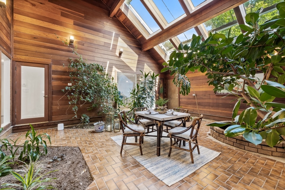 Sunlit Atrium, Stone Fireplace, and Shed-Style Roof? You Had Me at Atrium