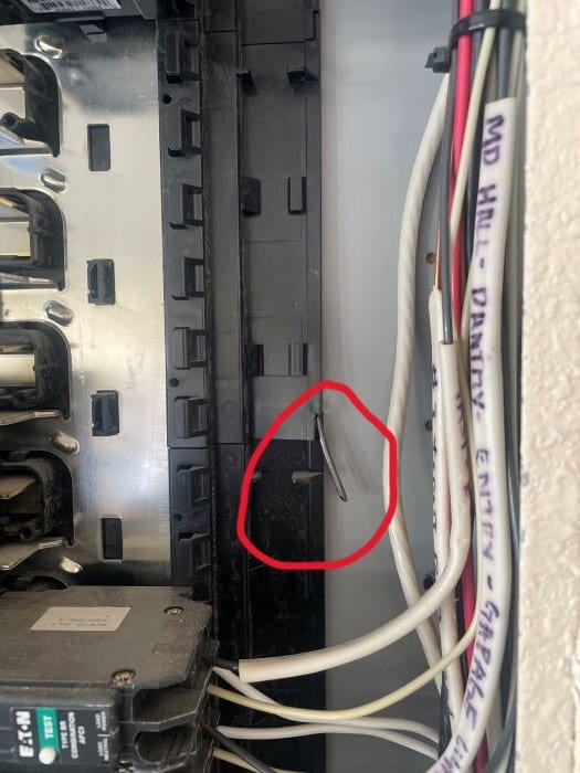 nail coming through the panel box housing