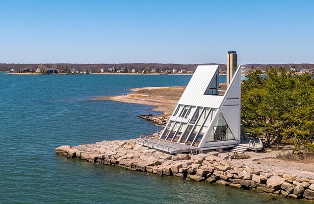 an-exterior-view-showcasing-the-homes-angular-facade-outdoor-areas-and-secluded-location