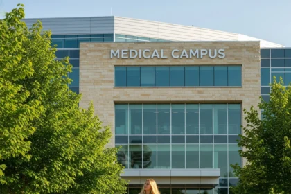 Medical student walking on campus toward building