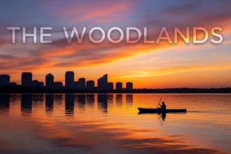 Sunrise on Lake Woodlands with kayaker and distant mid-rises