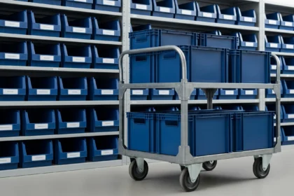 Matching organizer bins arranged on warehouse shelves and a rolling cart.