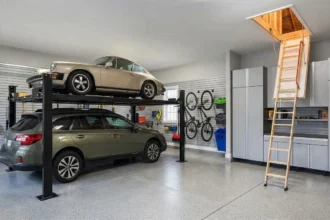 Organized residential garage with vertical storage, a car lift, and attic stairs