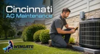 HVAC technician inspecting a Cincinnati home’s outdoor AC unit before summer heat