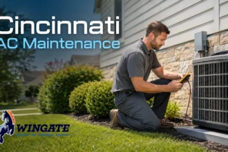 HVAC technician inspecting a Cincinnati home’s outdoor AC unit before summer heat