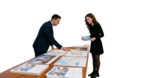 First-time investor reviewing pre-construction Dubai property plans in a modern sales gallery