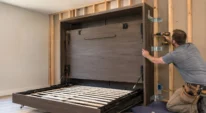 Murphy bed being mounted into wall studs